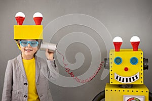 Happy child playing with robot