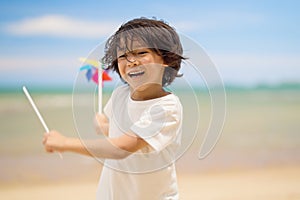 Happy child playing and running on sandy beach