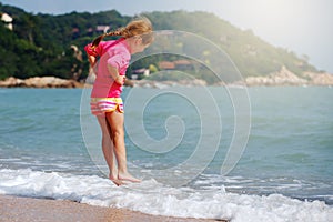 Happy child playing in sea.