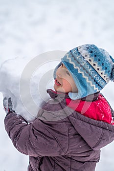 Happy child playing with snow