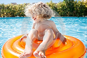 Happy child playing in swimming pool