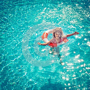 Happy child playing in swimming pool