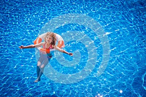 Happy child playing in swimming pool