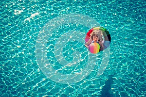 Happy child playing in swimming pool