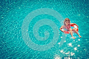 Happy child playing in swimming pool