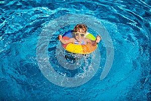 Happy child playing in swimming pool