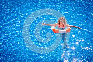 Happy child playing in swimming pool