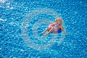 Happy child playing in swimming pool