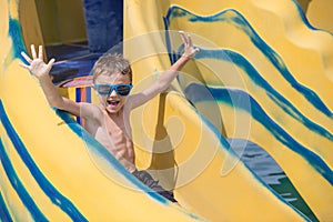 Happy child playing on the swimming pool at the day time.