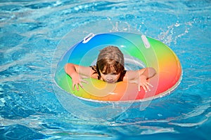 Happy child playing in swimming pool. Summer kids vacation.