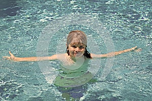 Happy child playing in swimming pool. Summer kids vacation.