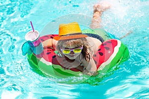 Happy child playing in swimming pool. Summer kids vacation. Child swim in poolside in water background.