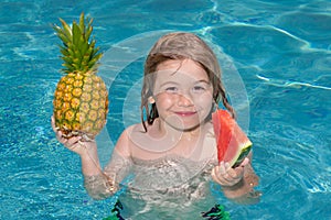 Happy child playing in swimming pool. Summer kids vacation. Summer pineapple amd watermelon fruit for children.