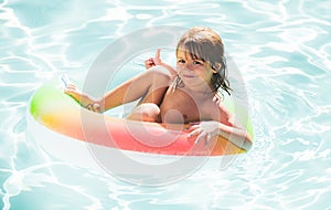 Happy child playing in swimming pool. Summer vacation.