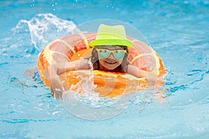 Happy child playing in swimming pool. Summer vacation concept. Summer kids portrait in sea water on beach.