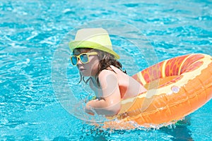 Happy child playing in swimming pool. Summer vacation concept. Summer kids portrait in sea water on beach.