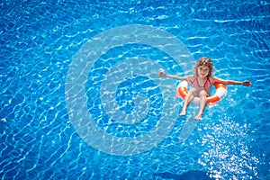 Happy child playing in swimming pool