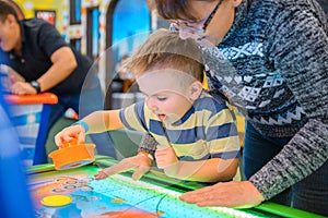 Happy child playing table air hockey