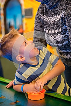 Happy child playing table air hockey