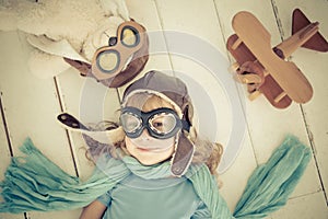 Happy child playing with toy airplane