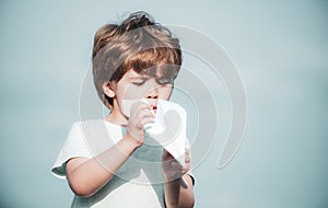 Happy child playing with toy airplane against summer sky background. Cute child on meadow with a toy paper airplane in