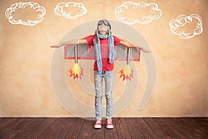 Happy child playing with toy jet pack