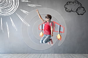 Happy child playing with toy jetpack