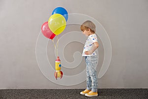 Happy child playing toy rocket
