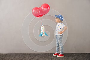 Happy child playing toy rocket