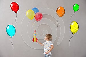 Happy child playing toy rocket