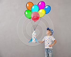 Happy child playing toy rocket