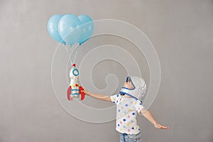 Happy child playing toy rocket