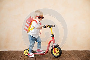 Happy child playing with toy rocket at home