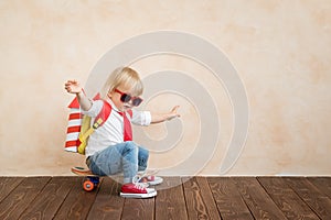 Happy child playing with toy rocket at home