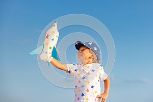 Happy child playing toy rocket outdoor