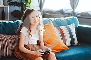 happy child playing video games with gamepad at home