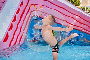 Happy child playing in water pool. outdoor recreation