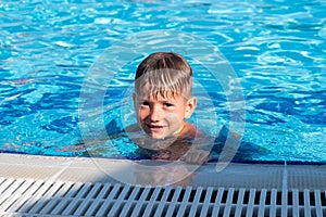 Happy child playing in water pool. swim wet