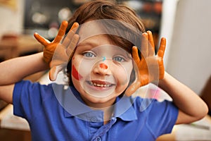 Happy child, portrait and face paint with color for artwork, craft or creativity at elementary school. Little male