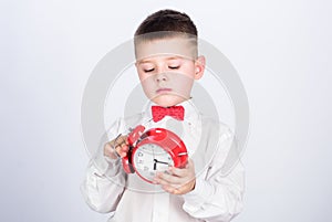 Happy child with retro clock in bow tie. tuxedo kid. Happy childhood. little boy with alarm clock. Time to relax. Party