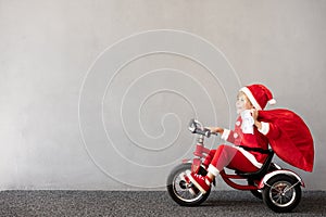 Happy child riding bike. Christmas holiday concept