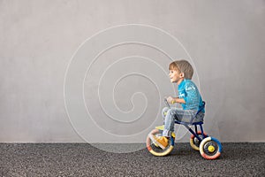 Happy child riding bike. Christmas holiday concept