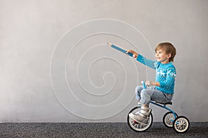 Happy child riding bike. Christmas holiday concept