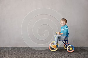 Happy child riding bike. Christmas holiday concept