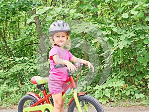 Happy child riding a bike in outdoor.