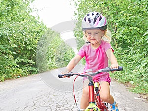 Happy child riding a bike in outdoor.