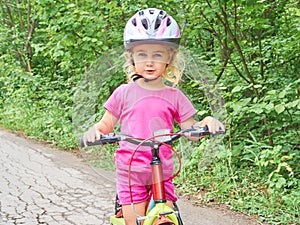 Happy child riding a bike in outdoor.