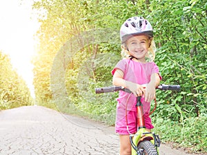 Happy child riding a bike in outdoor.