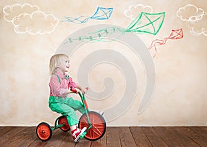 Happy child riding vintage tricycle