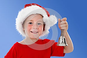 Happy child ringing bell on blue